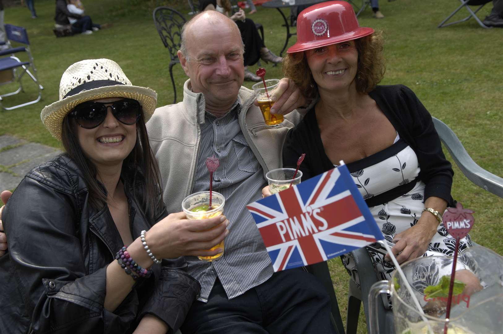 Jodi Bonner, Dave Mullins and Wendy Bonner enjoy a Pimms during a royal wedding garden party in April 2011