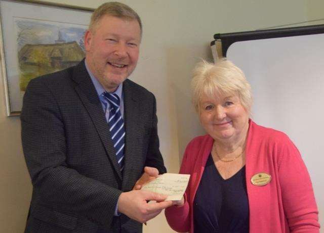 Canterbury Inner Wheel President Pat Wakeham presents a donation to KM Charity Team CEO Simon Dolby.