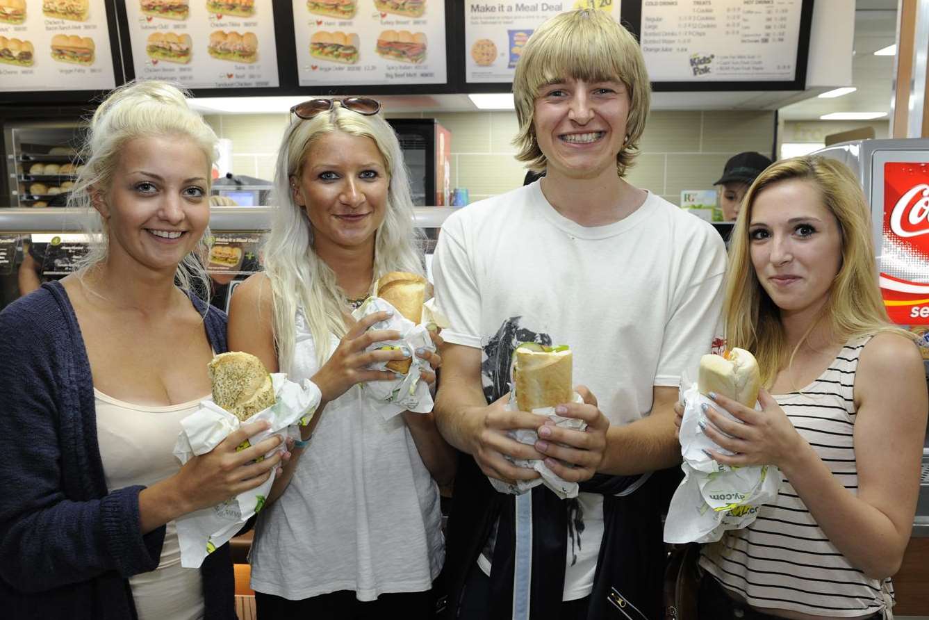 Happy and hungry customers enjoy their sub