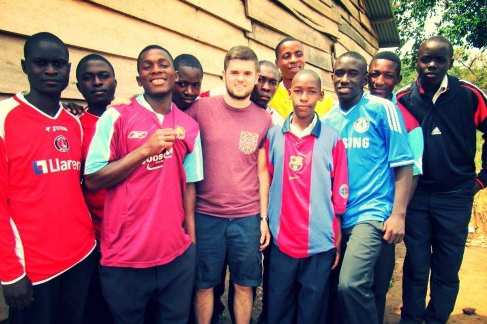 Mr Adkin with some of the lads from the SJCC wearing the donated football shirts.