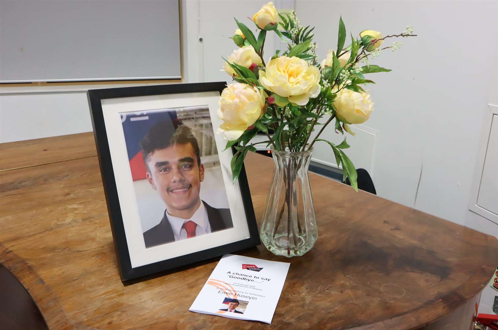 Flowers, portrait and programme for the ceremony to remember Emre Huseyin at Oasis Academy, Sheppey