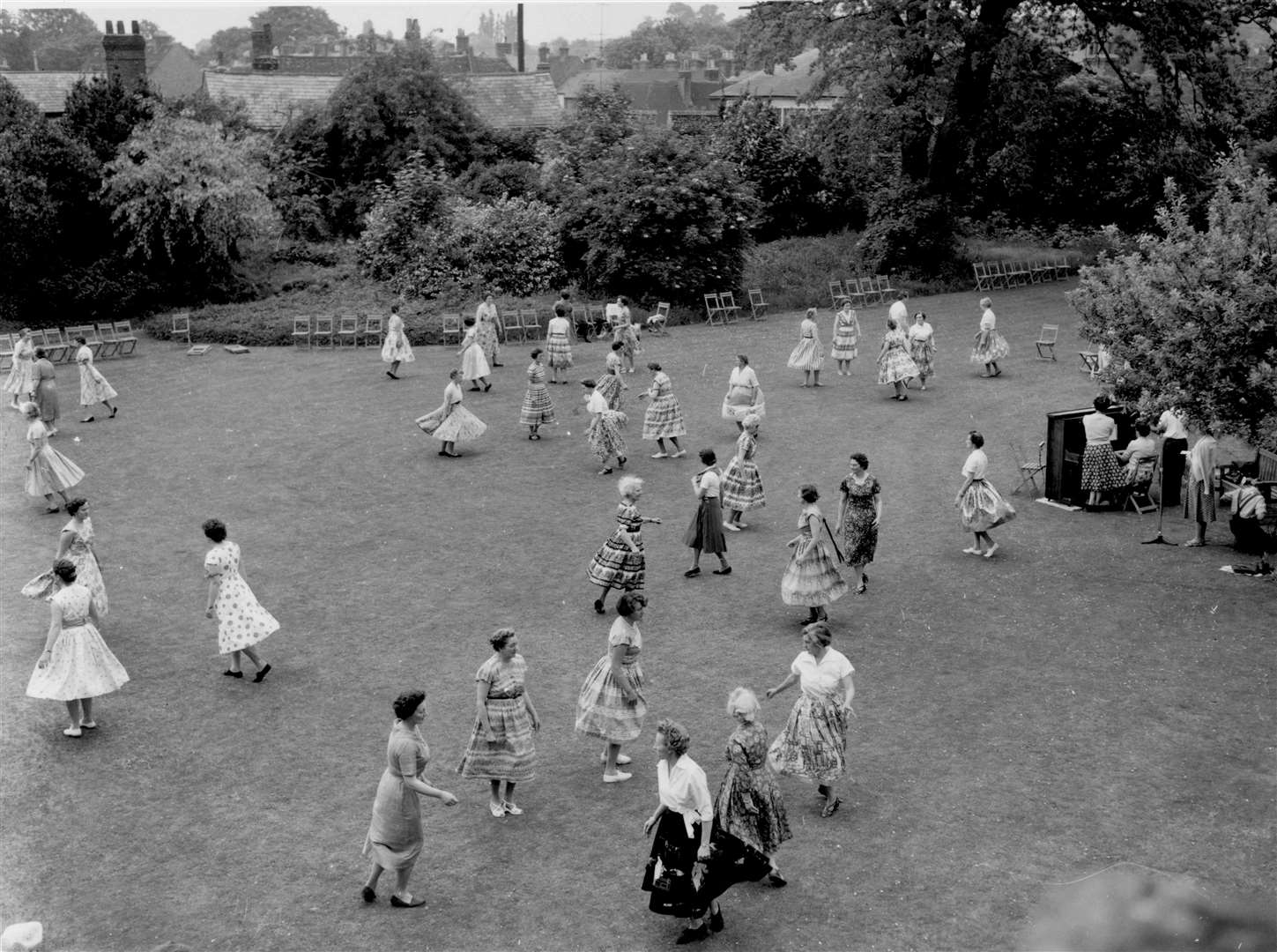 Members of the East Kent Federation of Women's Institutes enjoy an afternoon of country dancing in the Deanery Gardens, Canterbury, in May 1960