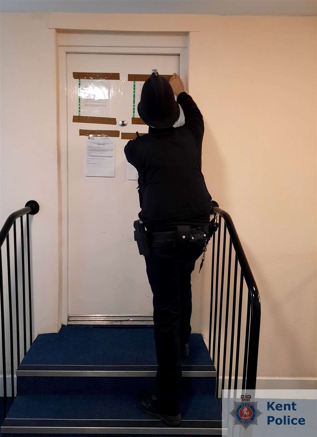 An officer attaches the closure order on the property
