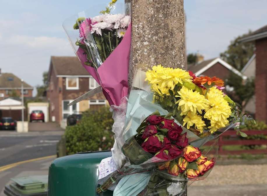 Flowers and cards on a lamppost outside the Monk's Head