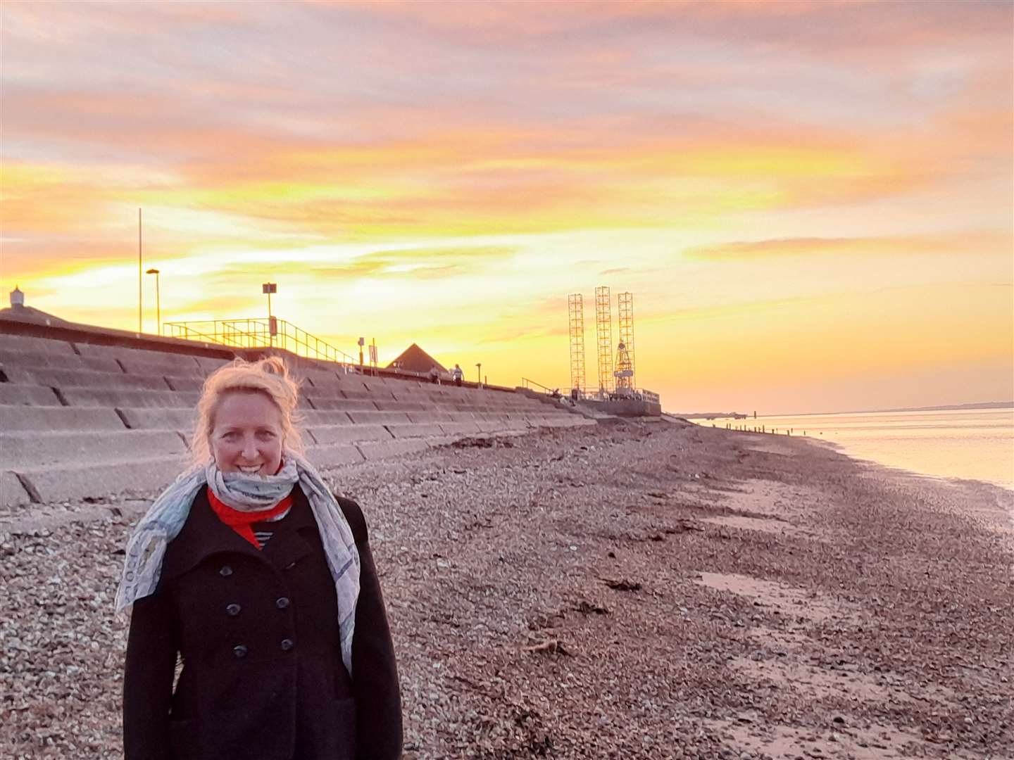 Artist Nicole Mollett taking a walk along the beach at Sheerness, Sheppey, at sunset