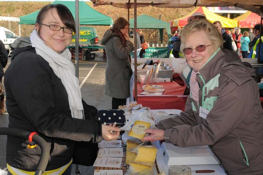 Kate Bradley buys some cheese from Doreen Bowyer at Ashmore Cheese