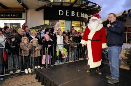 Santa's here - oh yes he is! Johnny introduces Father Christmas to the crowd