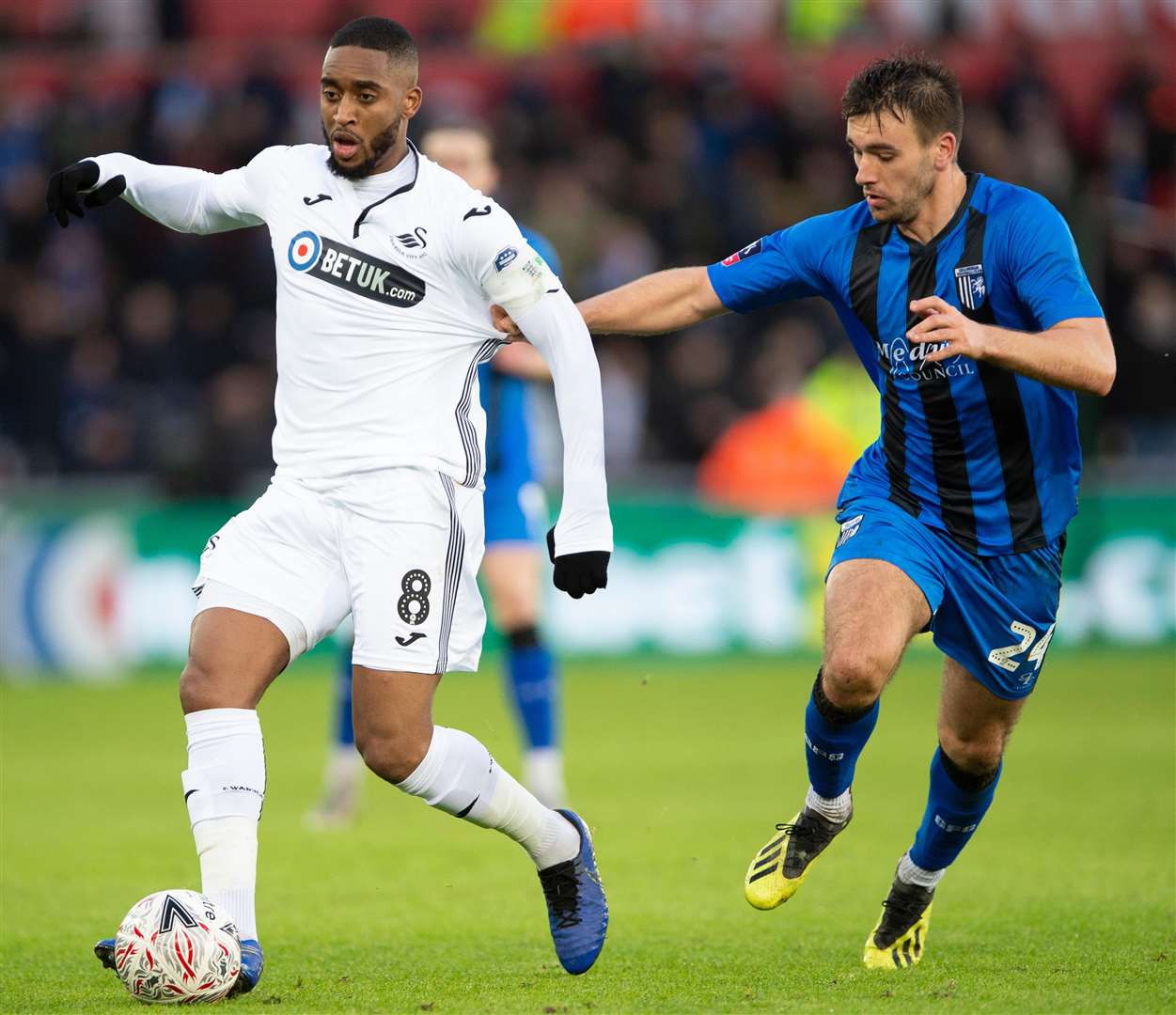 Josh Rees challenges Swansea's Leroy Fer during Saturday's FA Cup tie Picture: Ady Kerry