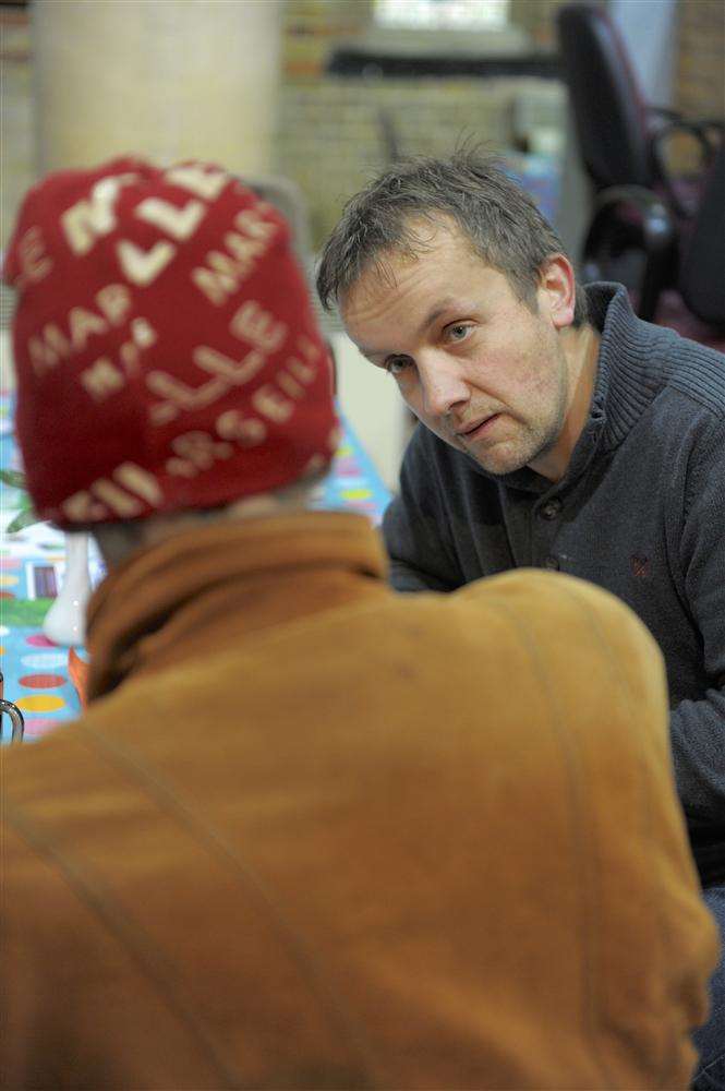 Food bank worker Wym Mauritz talks with a client at St Mark's Church, Gillingham, a distribution point