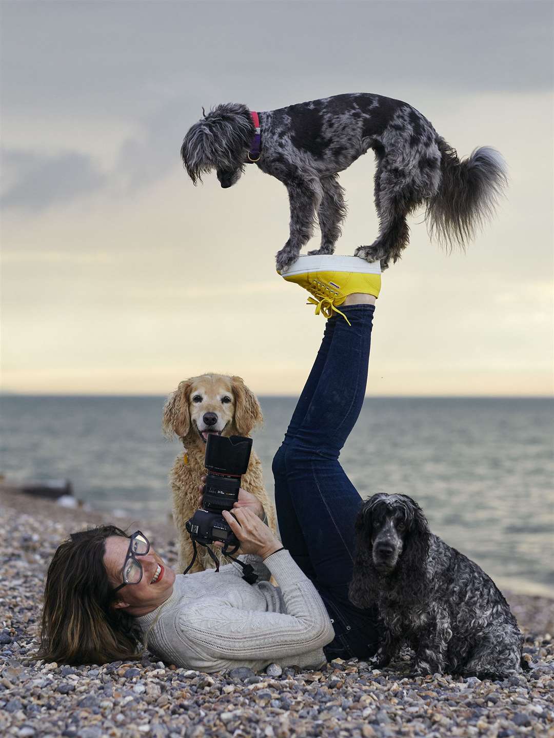 Liz Gregg playing with some of the dogs. Picture: Danielle Roughan