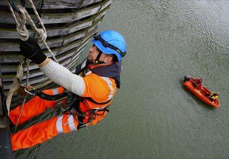 Workmen abseiling down the side of the Kingsferry Bridge