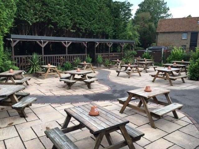 There is a large paved patio area at the back of the pub with a number of separate covered seating areas beyond that