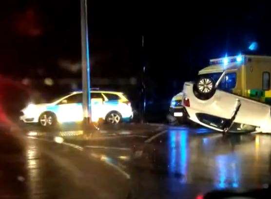 The car overturned after hitting a lamppost