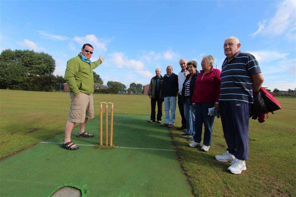 Mark Tucker with local residents on the cricket ground