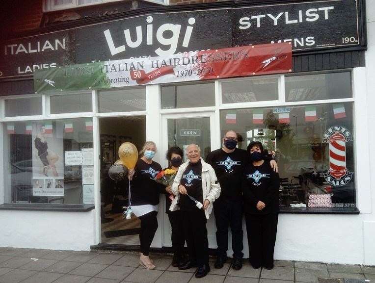 Luigi Antoncini celebrates outside his salon with staff (left), Sharon and Rachel, and family (right), Enzo and Camilla. Picture: David Hurley