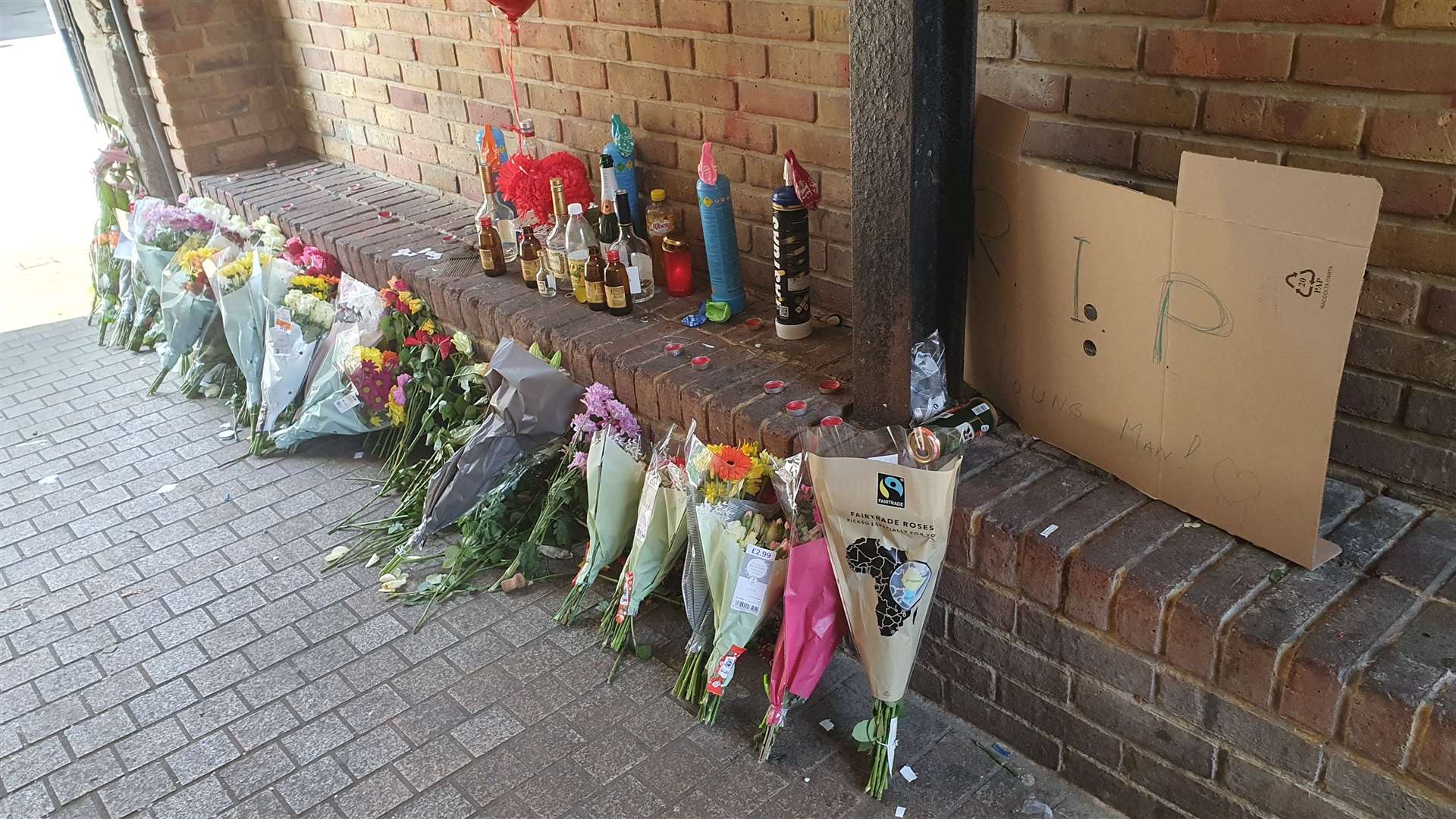 Tributes have been left to an 18-year-old stabbing victim line the alleyway in Dartford High Street