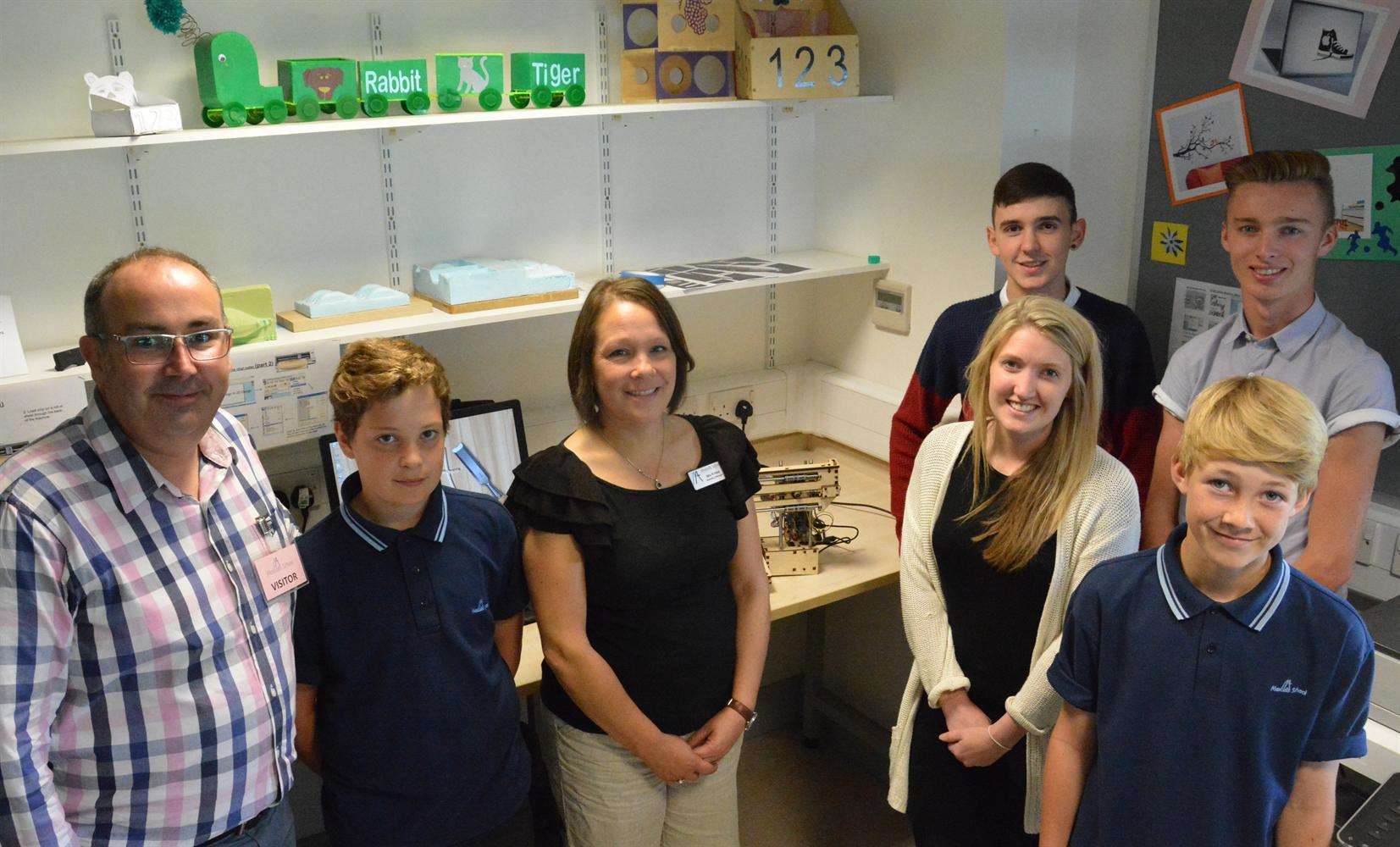 Mascalls staff members Rachel Hirst and Chloe James, centre, with design technology pupils and Chris Callander from BSK-CiC, far left