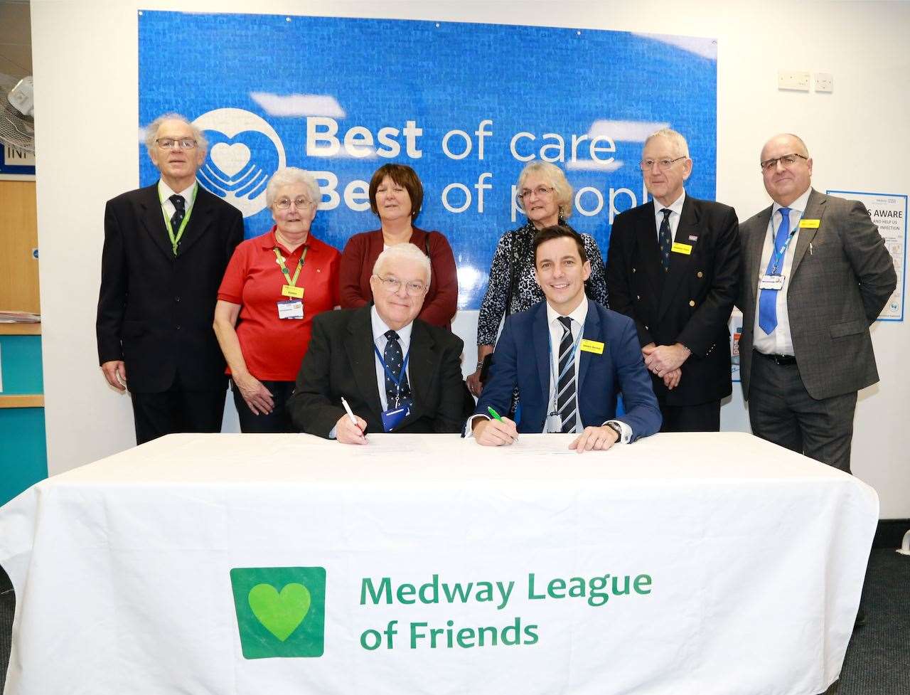 Friends' chairman Derek May (left) signs deal with James Devine, trust chief executive