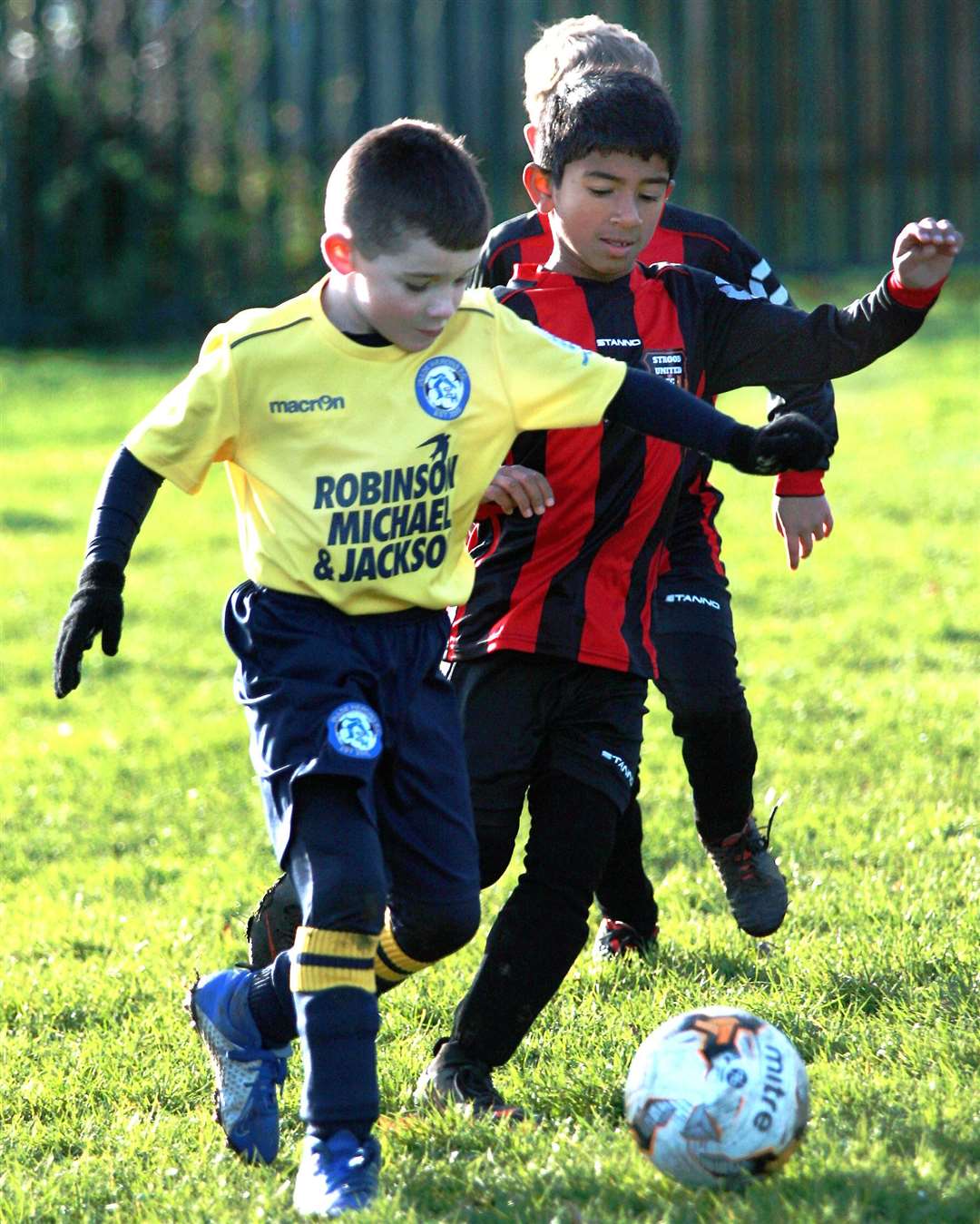 Strood United under-8s give chase against Iwade Herons United under-8s Picture: Phil Lee