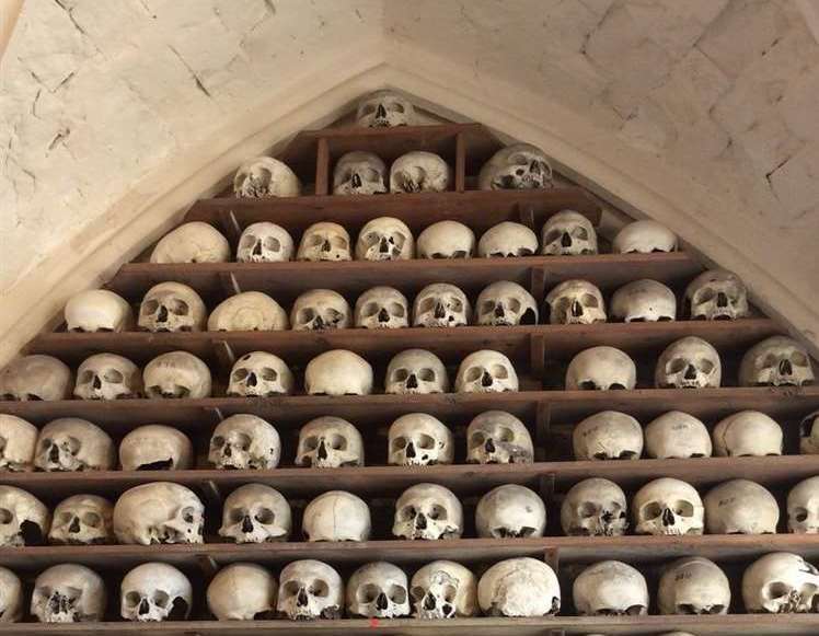 1,022 skulls are stacked on shelves in St Leonard's Church
