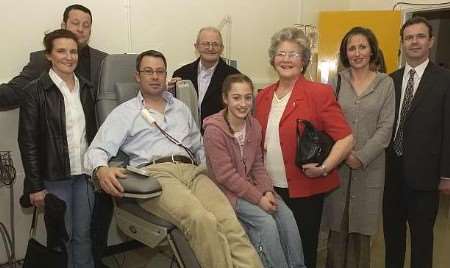 Family and friends of Kevin Hingley with the chair. Picture: CHRIS DAVEY