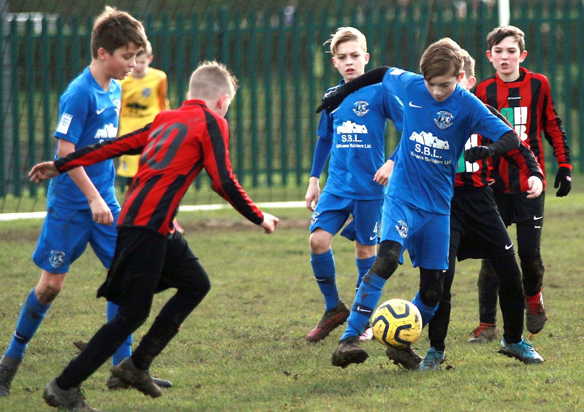 Medway United West under-12s (blue) are closed down by Woodcoombe Youth under-12s. Picture: Phil Lee FM28210271