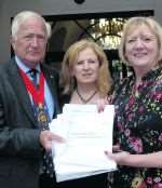 Yalding Parish Council chairman Geraldine Brown and Vivienne Robinson hand over petition to KCC chairman, Cllr Peter Lake. Picture: John Wardley