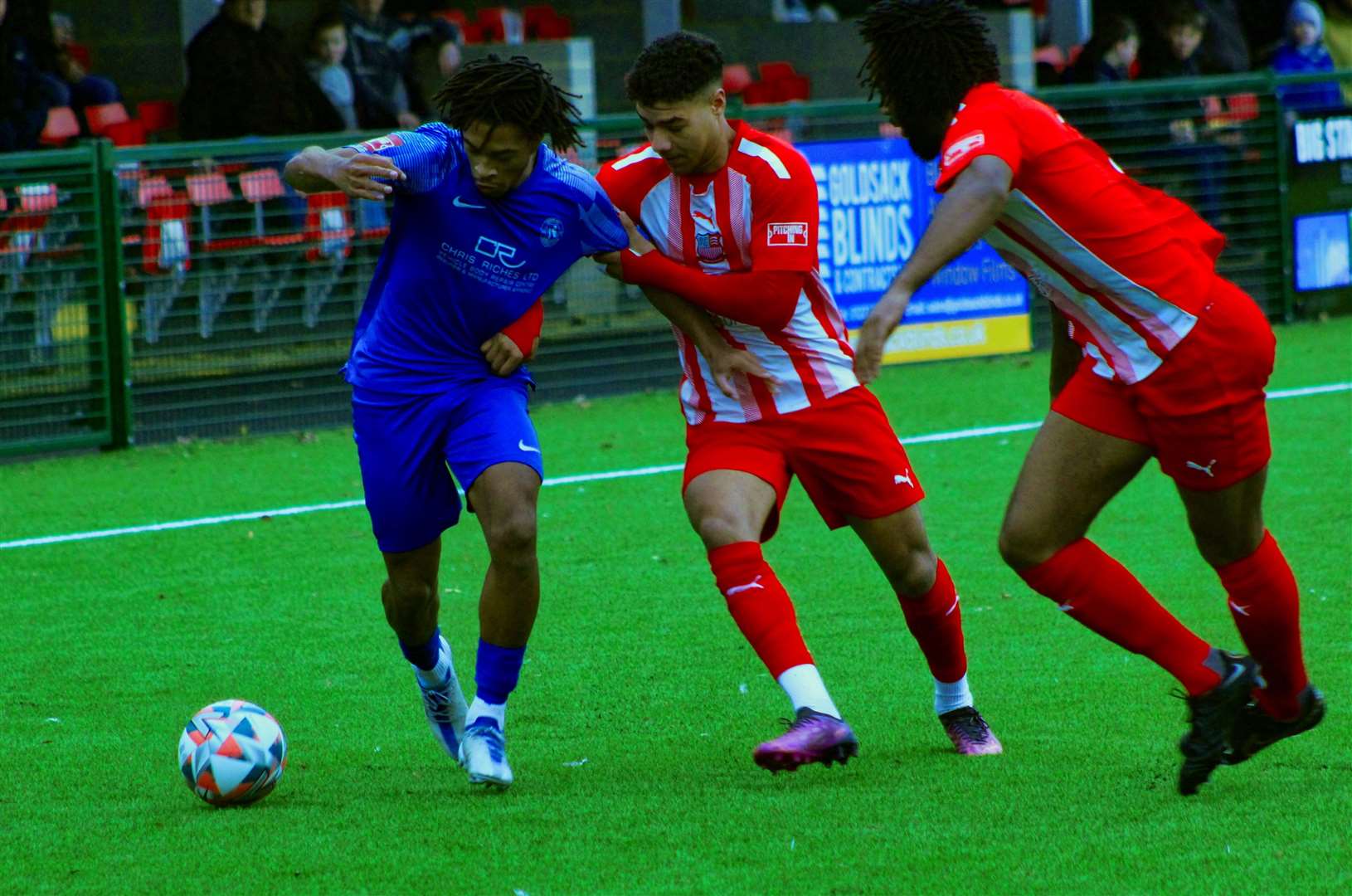 Herne Bay's Kymani Thomas being held by the Bowers & Pitsea defence. Picture: Keith Davy