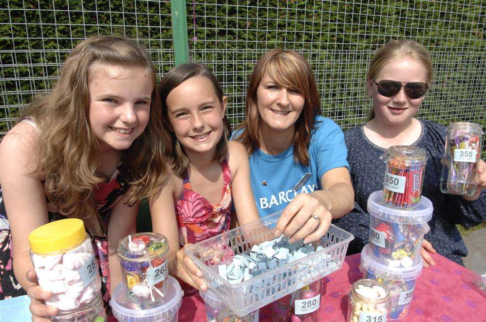 Sienna Bailey, 11, Ellie-Rose Fitch, 11, and Brooke Berry, 11, with Alison Beckham from Barclays Sheerness at the Elliott Park School summer fair