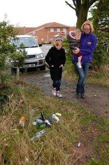 Isabelle Hallett and mum Rachel with childminded youngster Isabelle Norris walk past rubbish near Minster Hospital