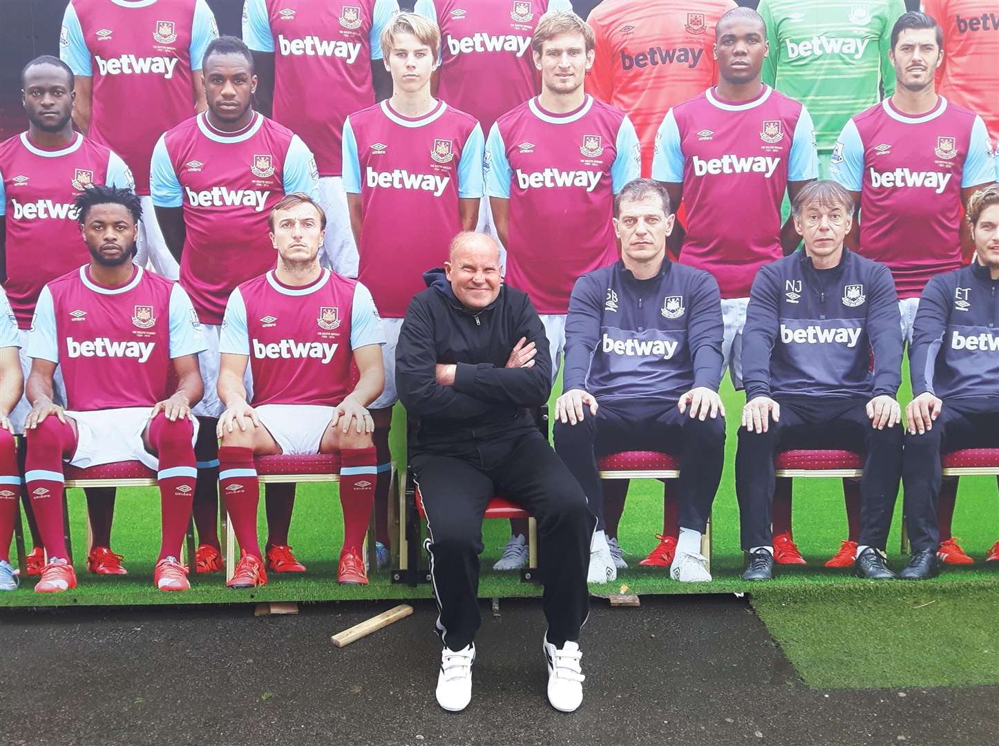 Robbie Manning poses with a picture of the 2015/16 West Ham squad