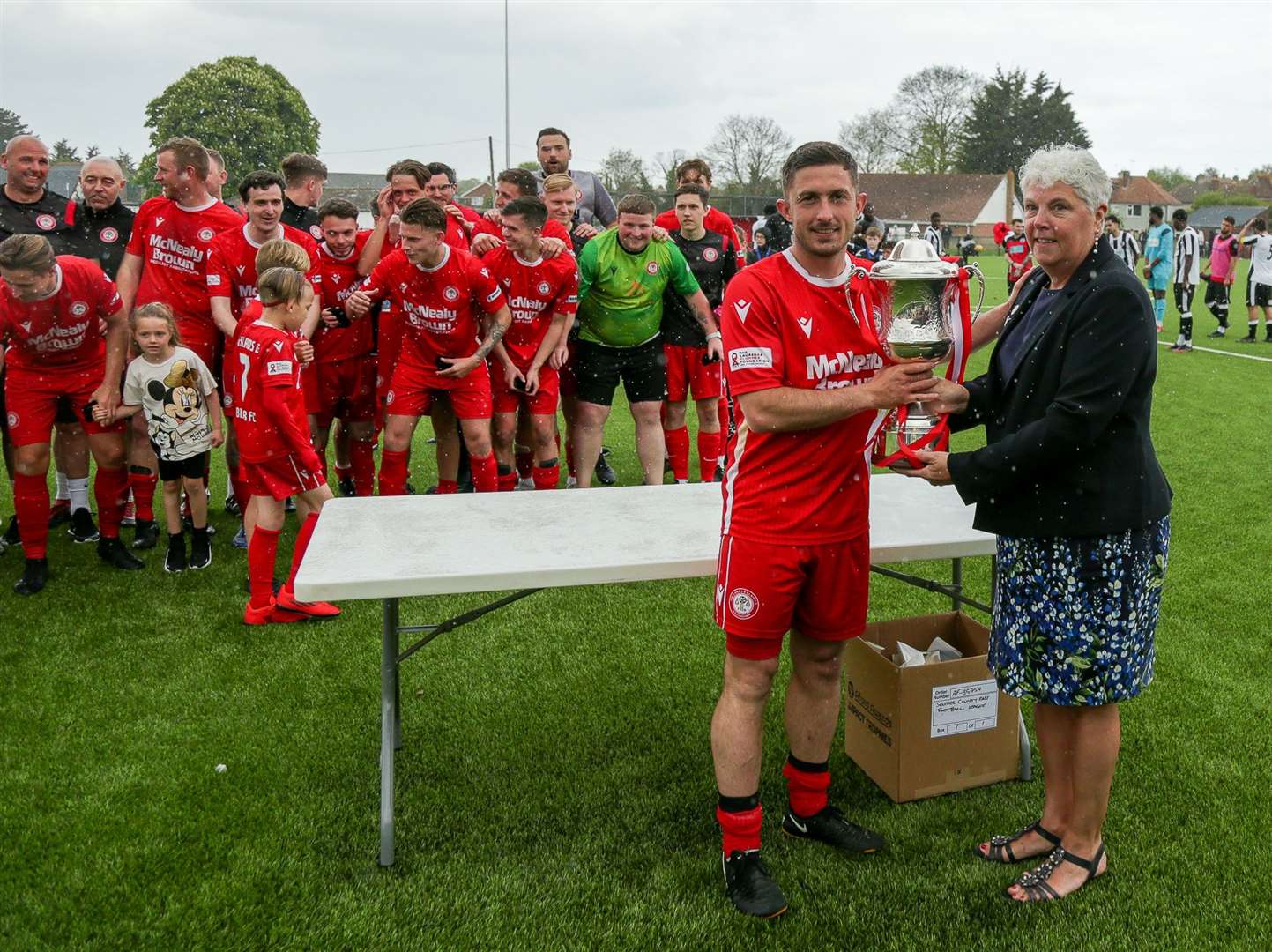 Southern Counties East Football league chair Denise Richmond presents the Challenge Cup to captain Louis Valencia Picture: Les Biggs
