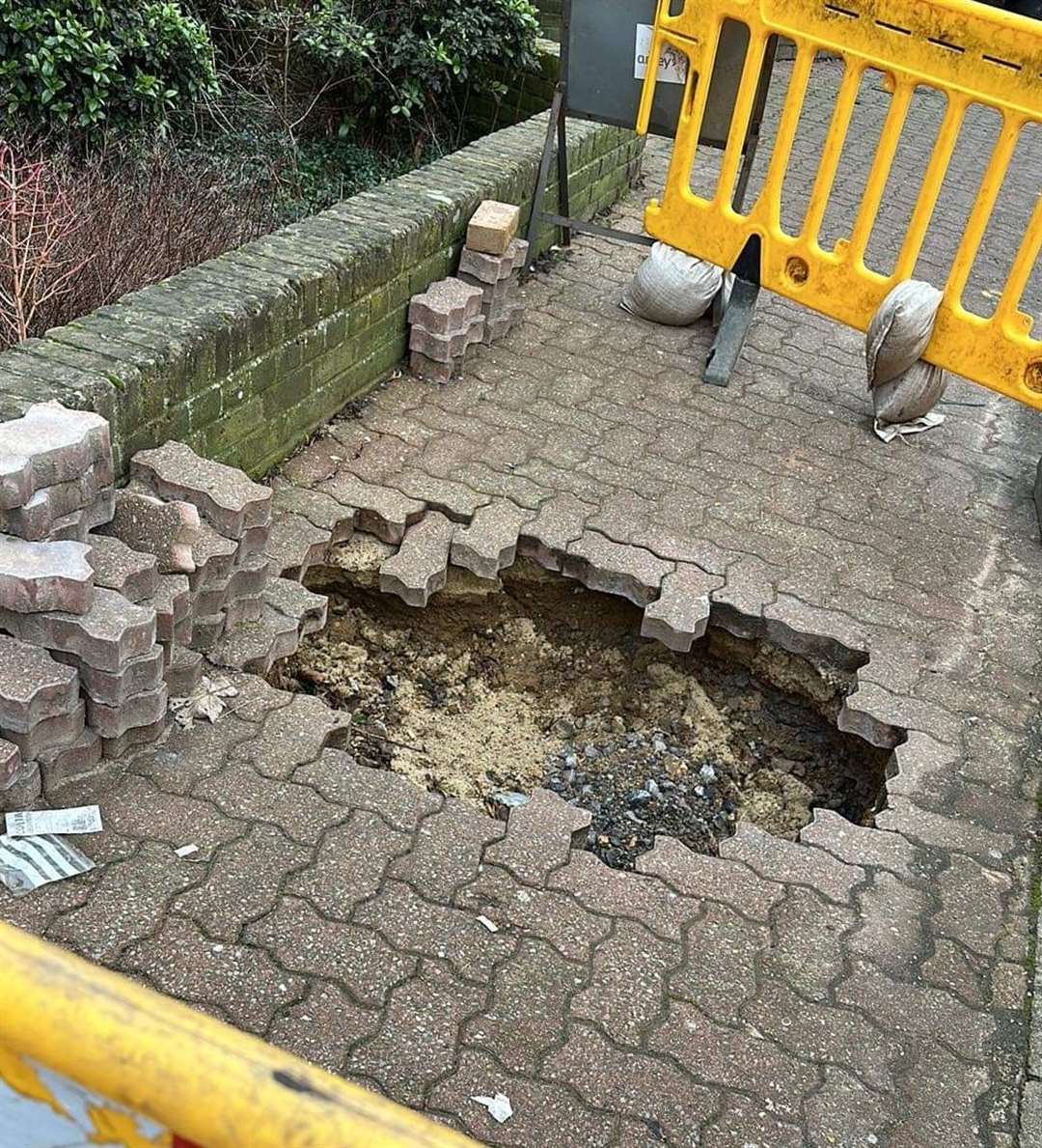 The hole outside the library and cafe in Main Road, Sutton-at-Hone