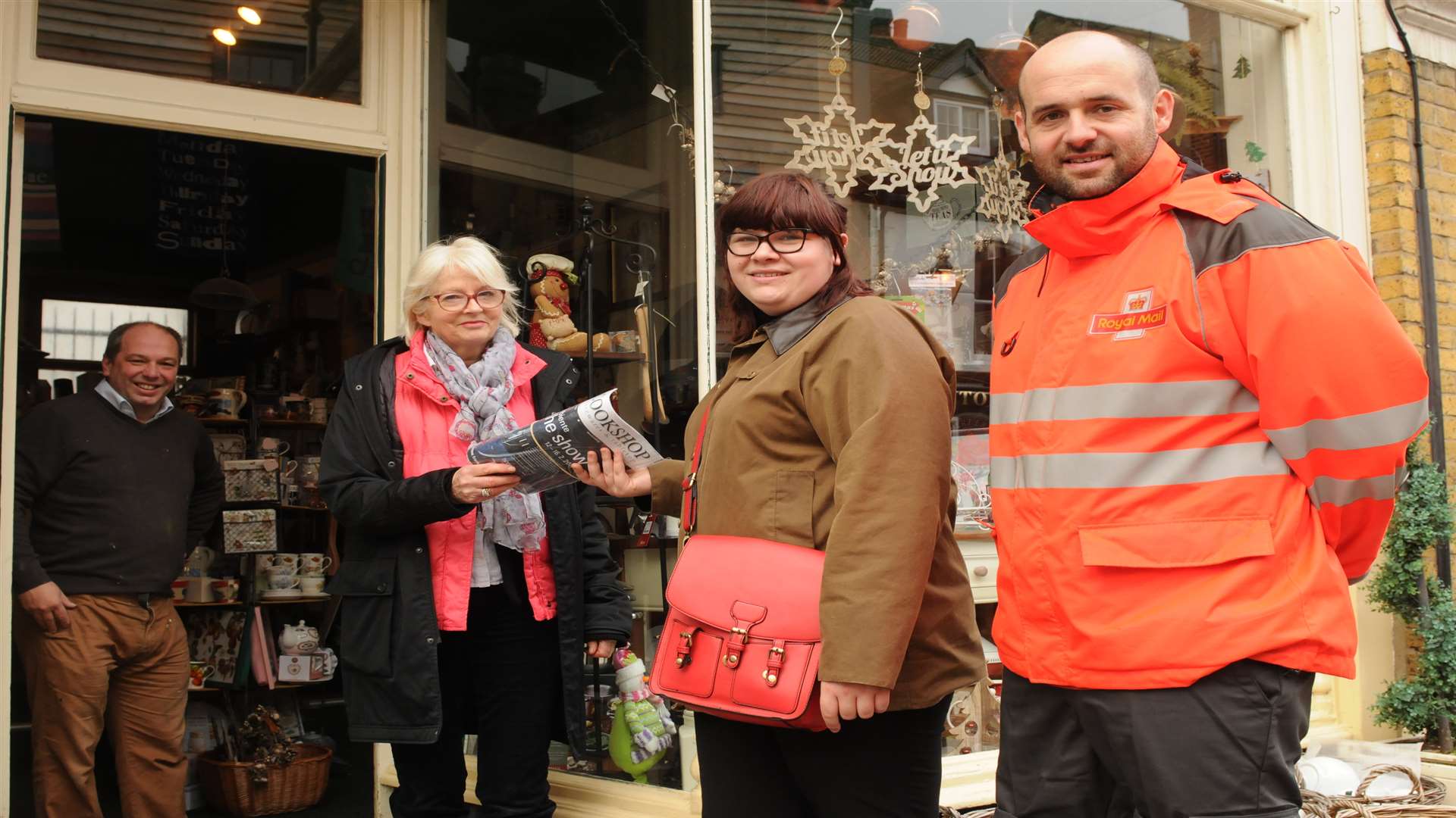 Reporter Jade Edwards and postman Rob Ashdown deliver post to Sue Hyland, owner of Pastures New on High Street, Rochester, and Shawn Hutchings.