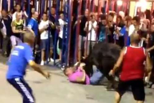 Others attempt to distract the bull as Peter is attacked
