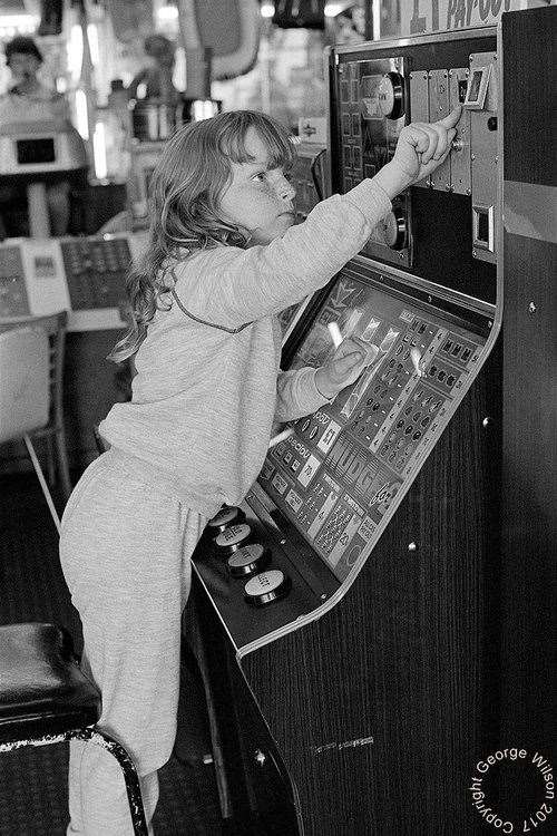 This girl reaches for the money slot at Cain's. Copyright: George Wilson