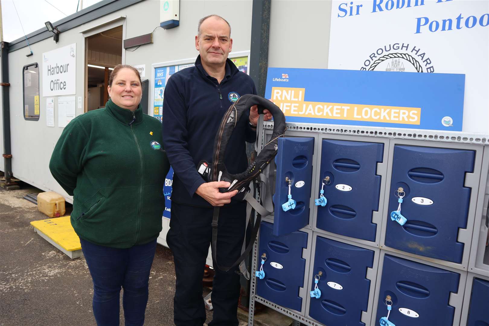 Deputy chairman Rachel Collier and harbour manager David Lavender with the 12 lockers donated by the RNLI where sailors can stow their life-vests before walking into Queenborough