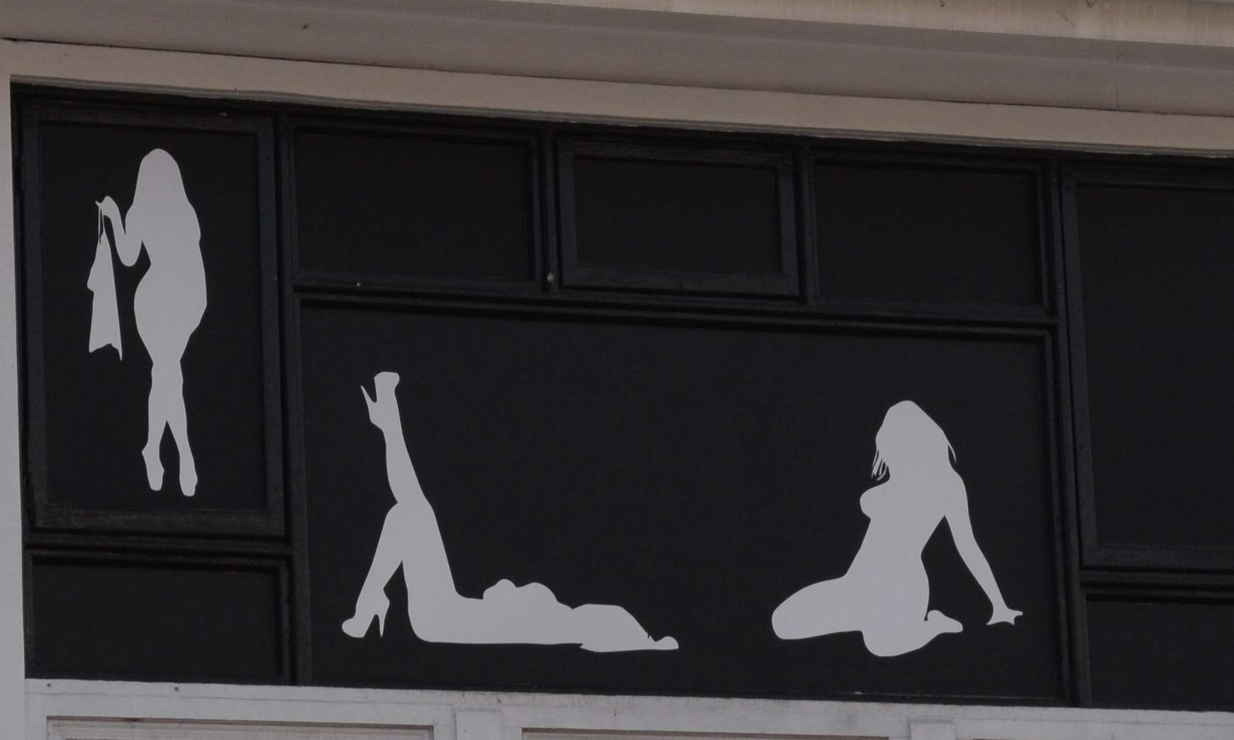 he silhouettes in the windows of the Bing Club in Dover Streeet, Canterbury