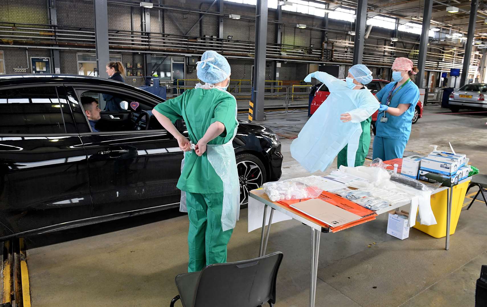 Health staff put on their PPE masks, gloves and gowns in Belfast (Justin Kernoghan/PA)