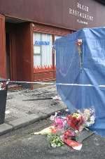 Floral tributes left outside the restaurant. Picture: PETER STILL