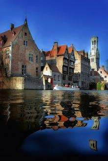 A boat tour is the perfect way to explore the web of canals in Bruges, Belgium. Picture: Jan Darthet/Toerisme Brugge
