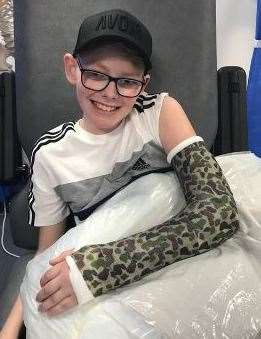 Harrison Martin in his camo cast after an operation to save his arm