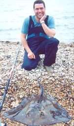 Trevor Back with his British record breaking stingray. Picture supplied by ALAN JEFFERY