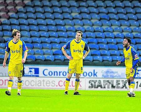 Gills players argues among themselves after Huddersfield's winner. Picture: Barry Goodwin
