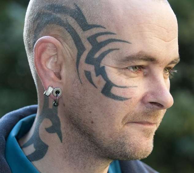 Bus driver Neil Collins shows off his tattoos
