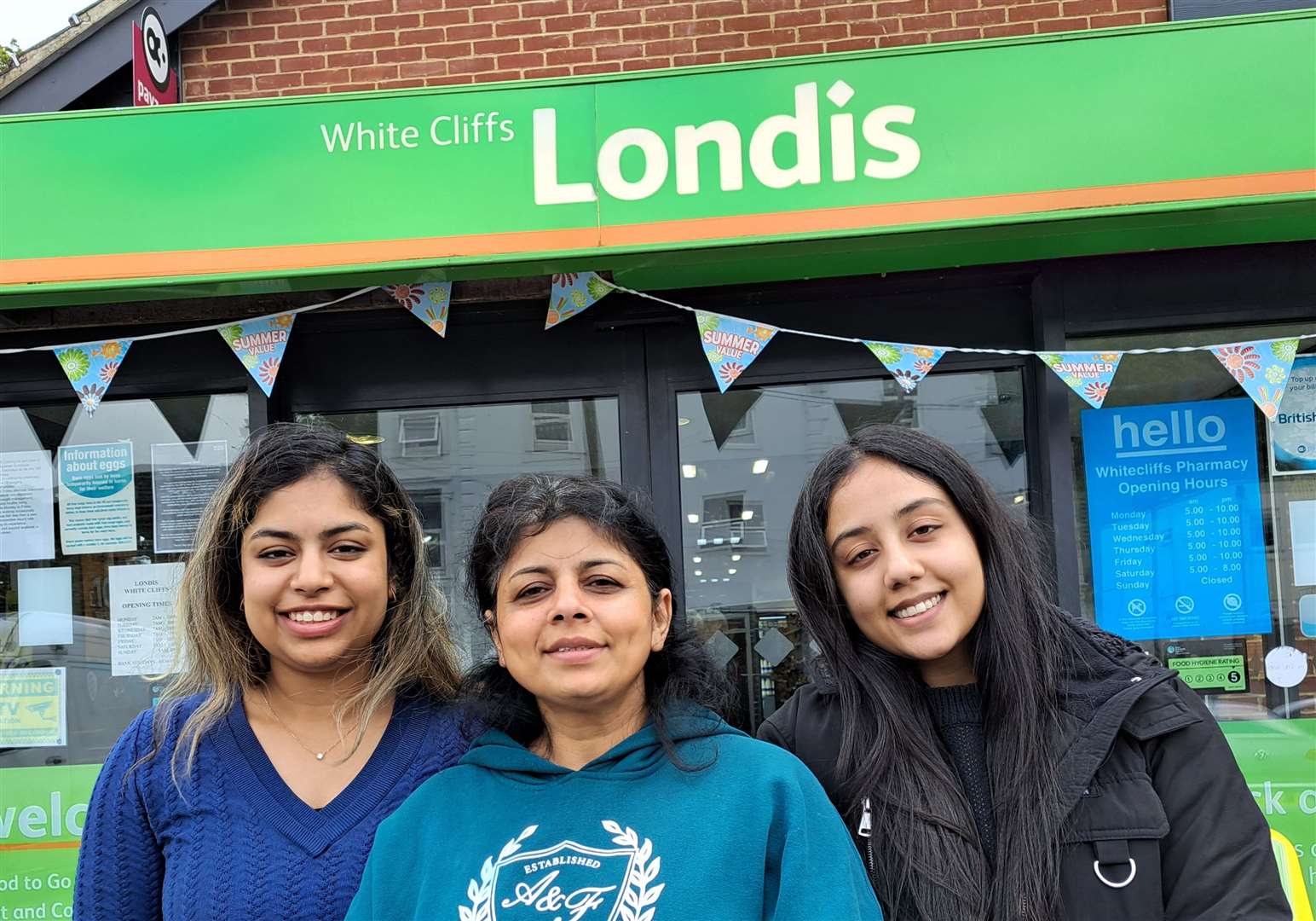 Shopkeeper Renu Jain, centre, at the Londis store in Folkestone Road with daughter Cherry Jain, left, and family friend Lavanya Tatiwala