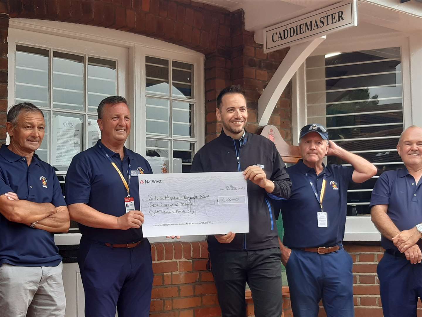 The caddies with Sky's Nick Dougherty, pictured centre, with the cheque. Picture: Dover District Council