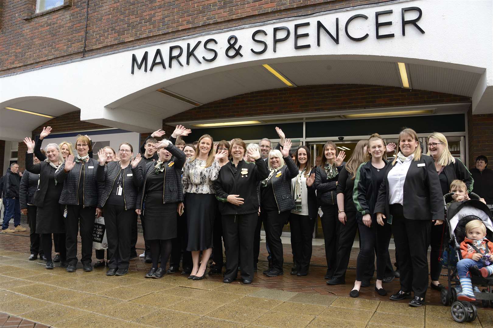 M&S staff pose for a picture outside the store on its final day in 2019