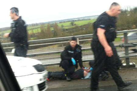 Police detain a man on the A2 at Cobham. Picture by Mick Fearne