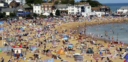 Sun worshippers on Broadstairs beach - how many like to enjoy a sunny day